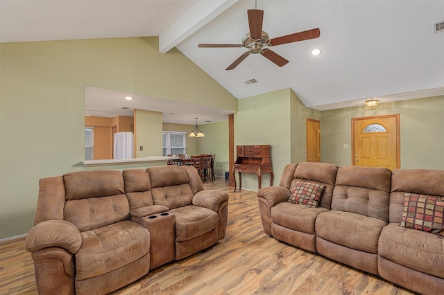 living room with ceiling fan, high vaulted ceiling, beam ceiling, and light hardwood / wood-style floors