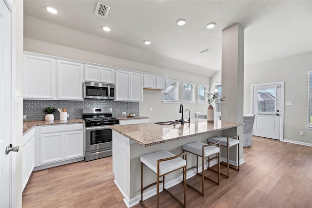 kitchen with sink, stainless steel appliances, and white cabinets