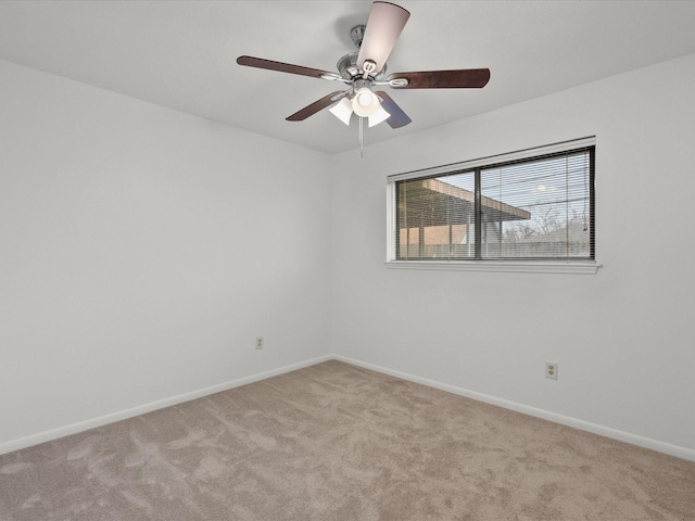 empty room with ceiling fan and light carpet