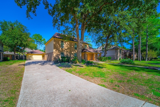 view of front of property featuring a garage and a front yard