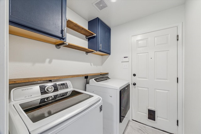 washroom featuring cabinets and washer and dryer