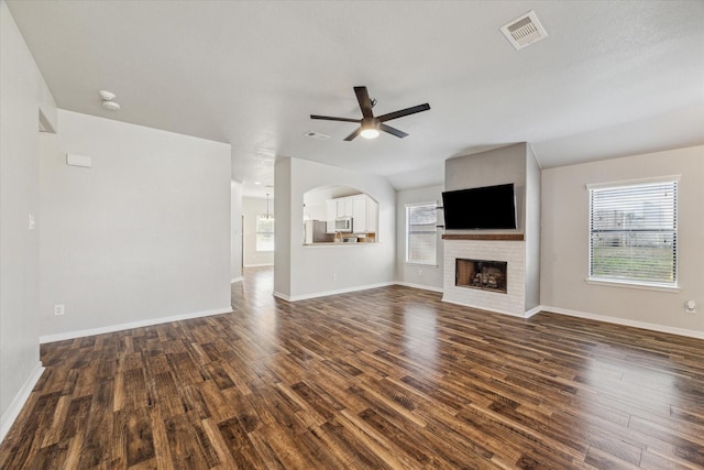 unfurnished living room with dark wood-type flooring and ceiling fan