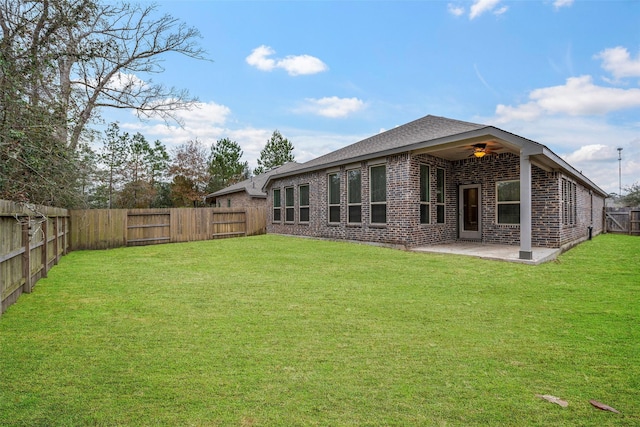 rear view of house featuring a patio, ceiling fan, and a lawn