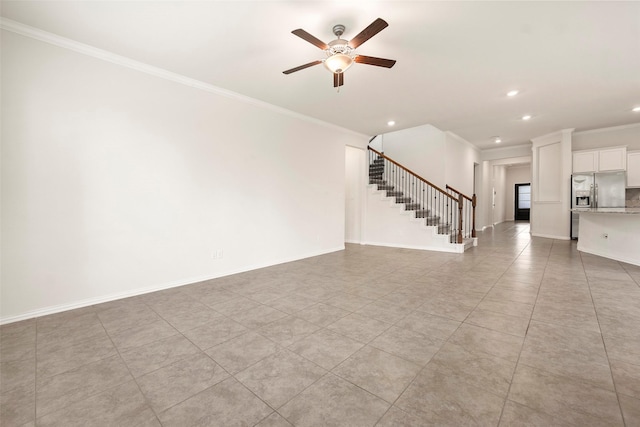 tiled empty room with ceiling fan and ornamental molding