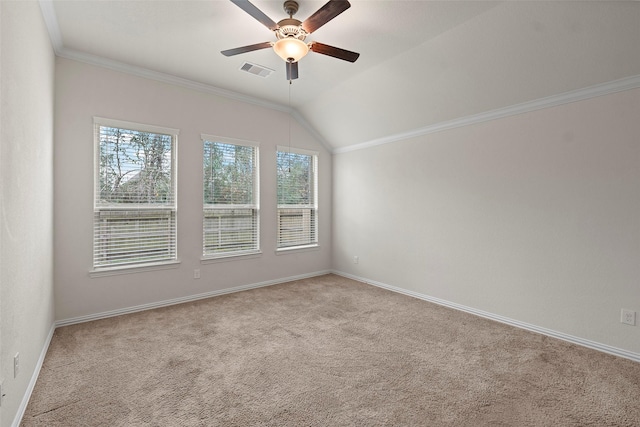 unfurnished room with ornamental molding, vaulted ceiling, light carpet, and ceiling fan