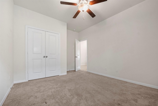 unfurnished bedroom with light carpet, ceiling fan, and a closet