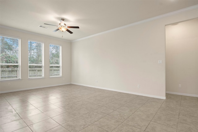 empty room featuring ceiling fan, ornamental molding, and light tile patterned floors