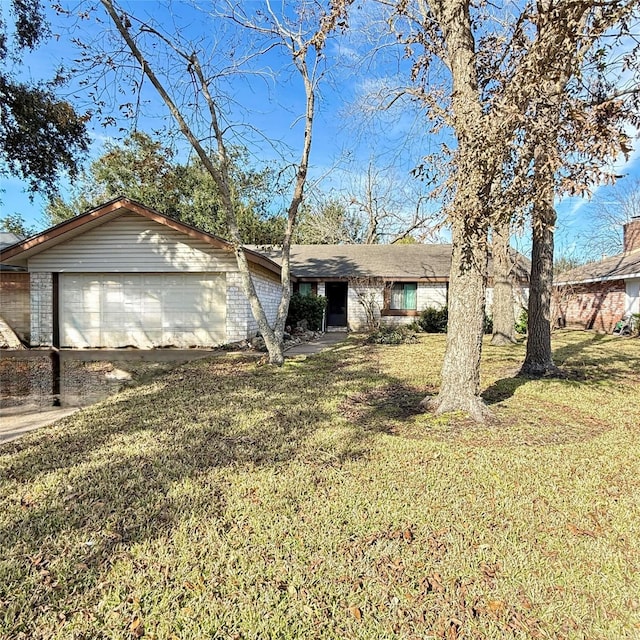 single story home with a front yard and brick siding