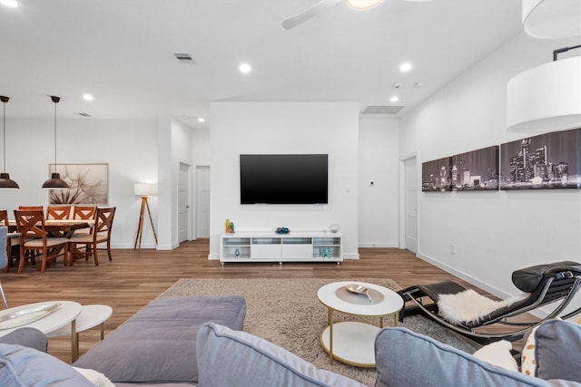 living room with ceiling fan and light wood-type flooring