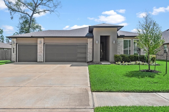 prairie-style home with a garage and a front yard