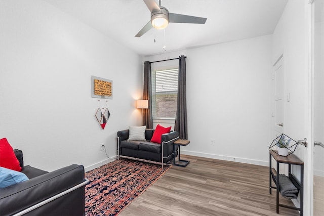 sitting room featuring ceiling fan and wood-type flooring