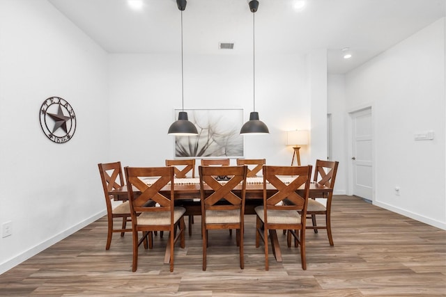 dining area with hardwood / wood-style floors