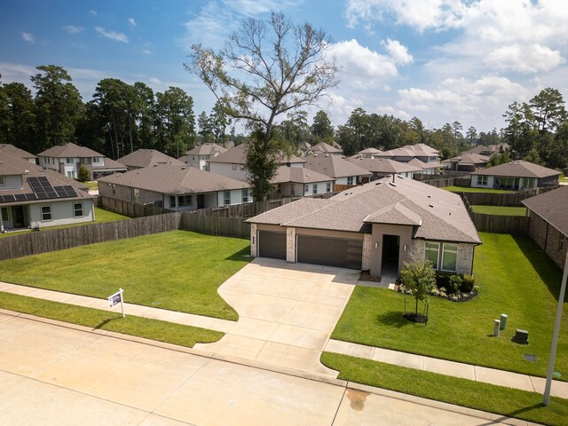 view of front of house featuring a garage and a front lawn