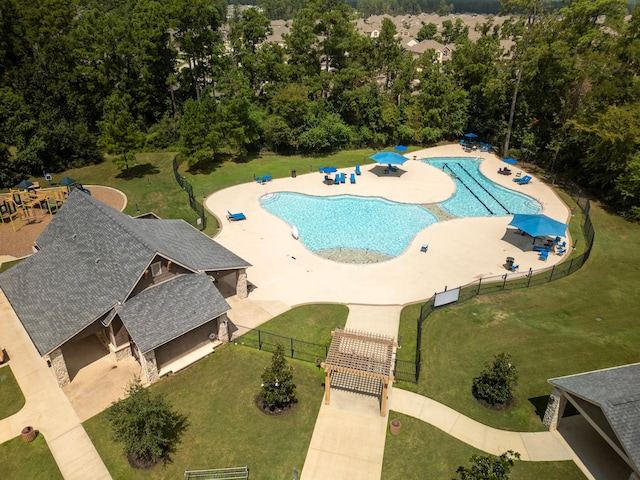 view of swimming pool featuring a yard and a patio