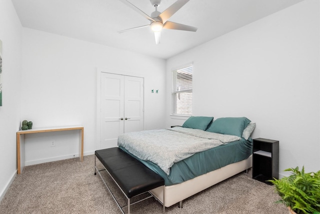 carpeted bedroom with a closet and ceiling fan