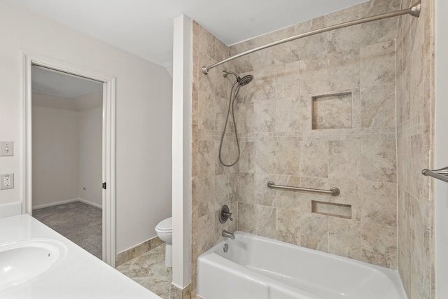 full bathroom with vanity, tiled shower / bath combo, and toilet