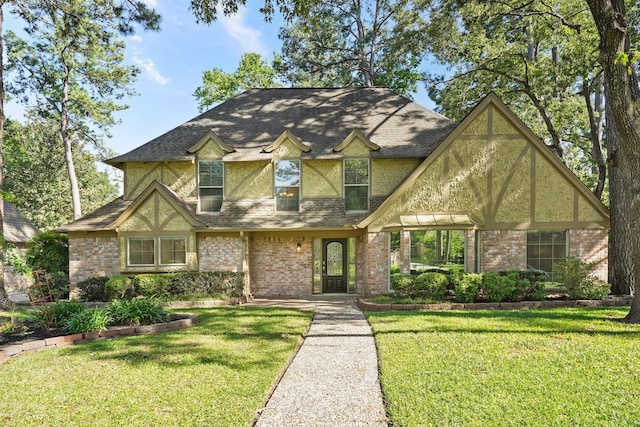 tudor home with a front lawn