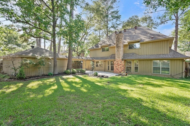 rear view of house featuring a yard and a patio area