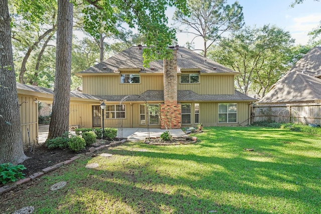 back of property featuring a yard and a patio area