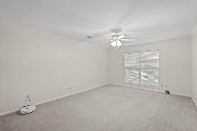 carpeted empty room featuring crown molding and ceiling fan