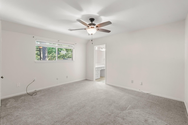 empty room with ceiling fan and light colored carpet