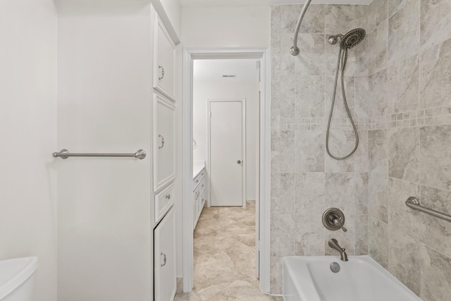 full bathroom with vanity, toilet, and tiled shower / bath