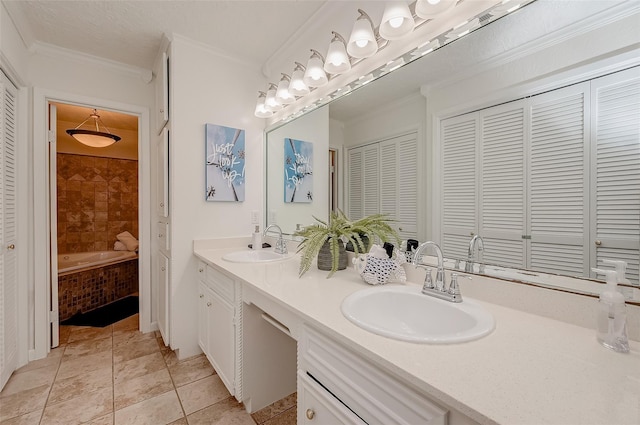 bathroom with a relaxing tiled tub, ornamental molding, vanity, and tile patterned floors