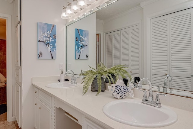 bathroom with ornamental molding and vanity