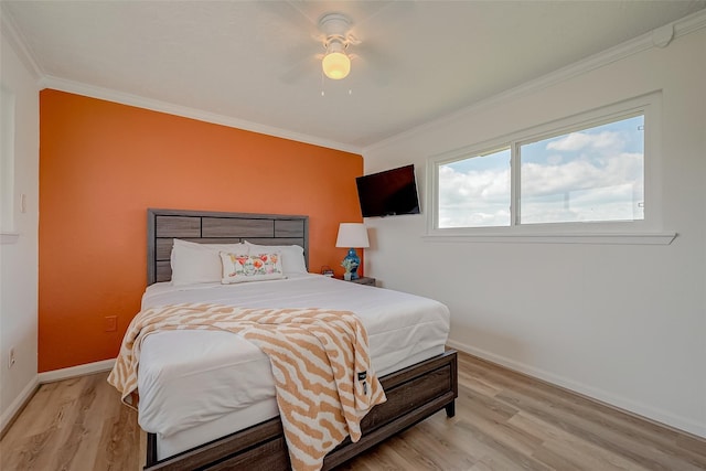 bedroom featuring light hardwood / wood-style flooring, ornamental molding, and ceiling fan