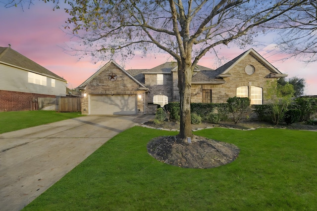 view of front of property featuring a garage and a yard