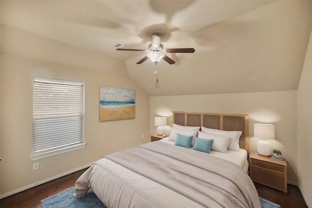 bedroom featuring dark wood-type flooring, vaulted ceiling, and ceiling fan