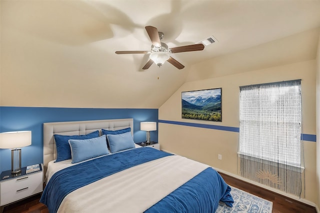 bedroom featuring lofted ceiling, dark hardwood / wood-style floors, and ceiling fan