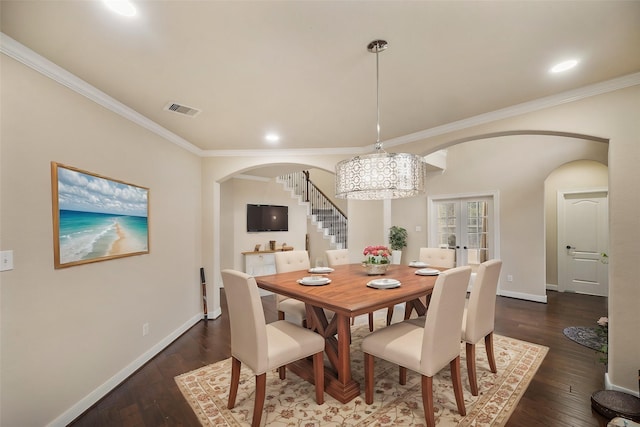 dining space featuring crown molding, dark hardwood / wood-style floors, french doors, and a notable chandelier