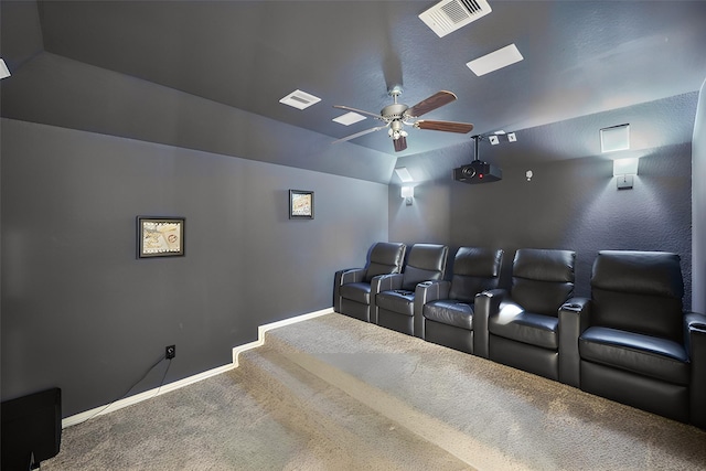 home theater with vaulted ceiling, carpet flooring, and ceiling fan