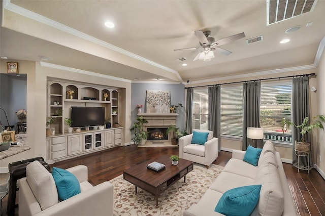 living room featuring hardwood / wood-style flooring, ceiling fan, ornamental molding, and vaulted ceiling