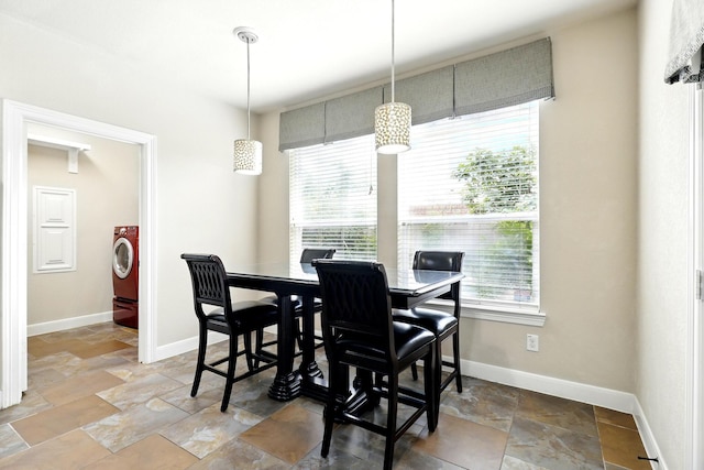 4715 Cedarfield Rd, Katy, TX 77494 - dining space with stone tile flooring, washer / clothes dryer, and baseboards
