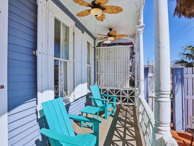 balcony featuring ceiling fan and a porch