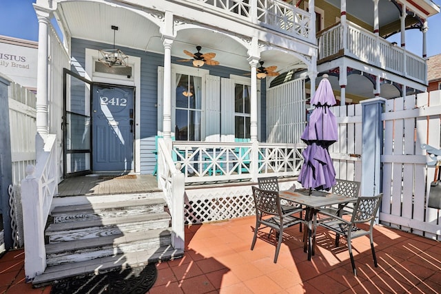 exterior space featuring ceiling fan, a porch, and outdoor dining area