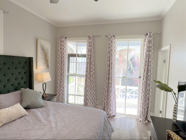 bedroom featuring access to outside, crown molding, baseboards, and wood finished floors