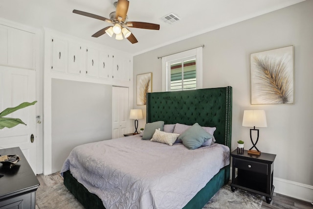 bedroom featuring a closet, visible vents, ceiling fan, light wood-type flooring, and baseboards