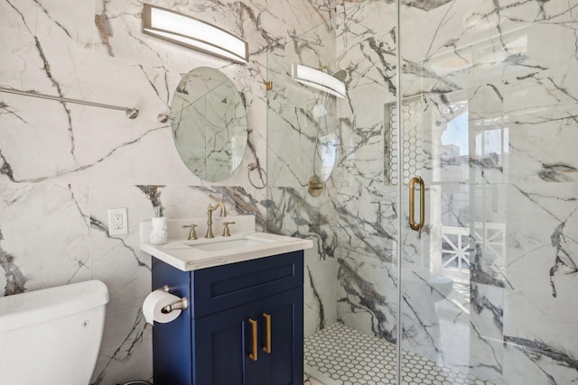 full bathroom with tile walls, toilet, vanity, and a marble finish shower