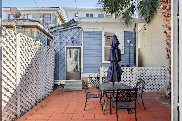 view of patio featuring entry steps and fence