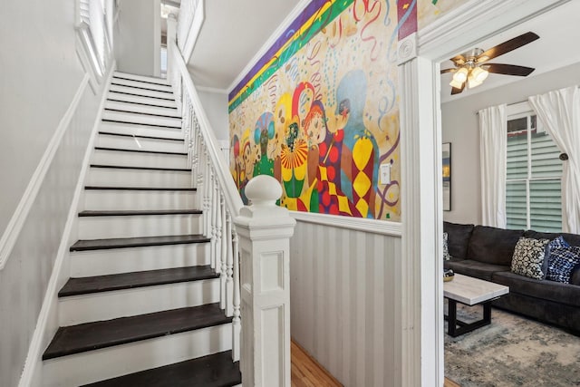 stairs with ceiling fan and wood finished floors