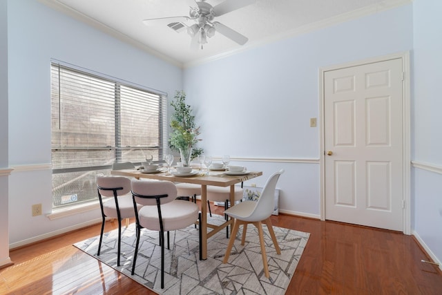 dining room with ceiling fan, ornamental molding, and hardwood / wood-style floors