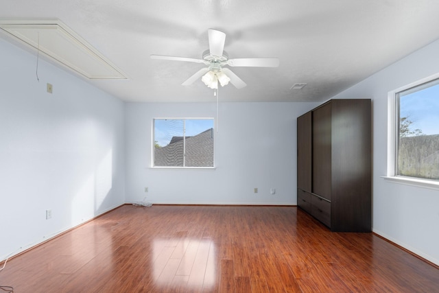 empty room featuring ceiling fan and dark hardwood / wood-style flooring