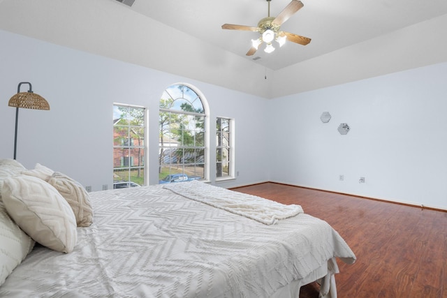 bedroom with wood-type flooring, vaulted ceiling, and ceiling fan