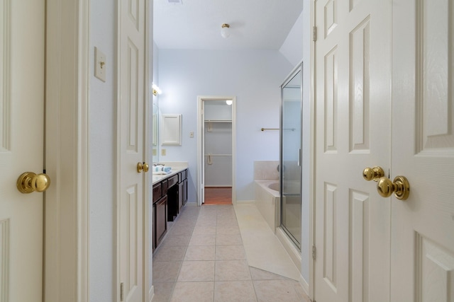 bathroom with tile patterned flooring, vanity, and separate shower and tub