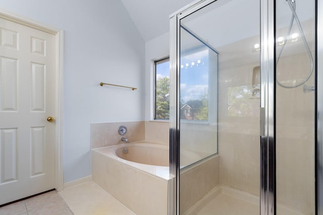 bathroom featuring vaulted ceiling, tile patterned floors, and independent shower and bath