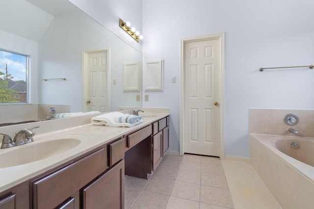 bathroom with tile patterned flooring, vanity, and a bathing tub