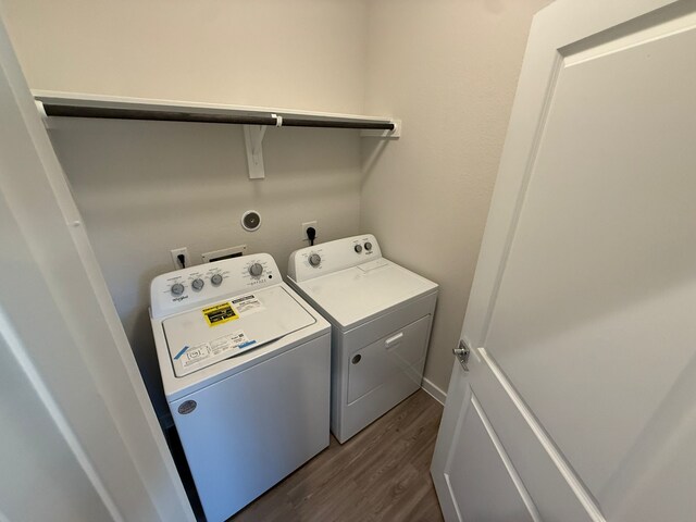 laundry area featuring separate washer and dryer and dark hardwood / wood-style flooring